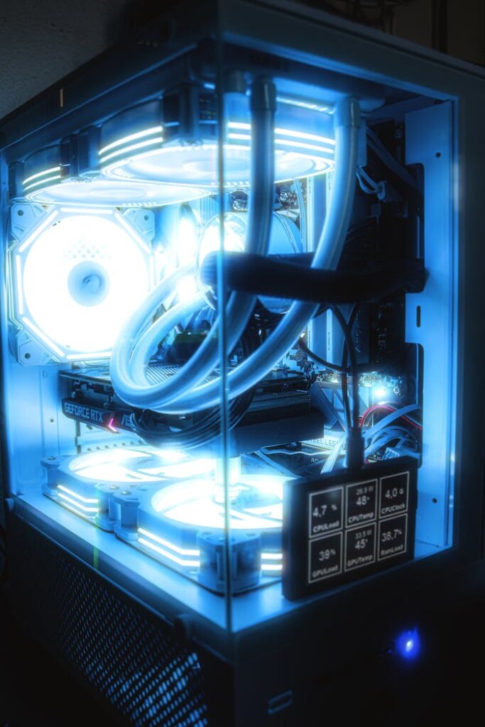 High-performance gaming PC setup featuring blue LED lighting and advanced cooling system.